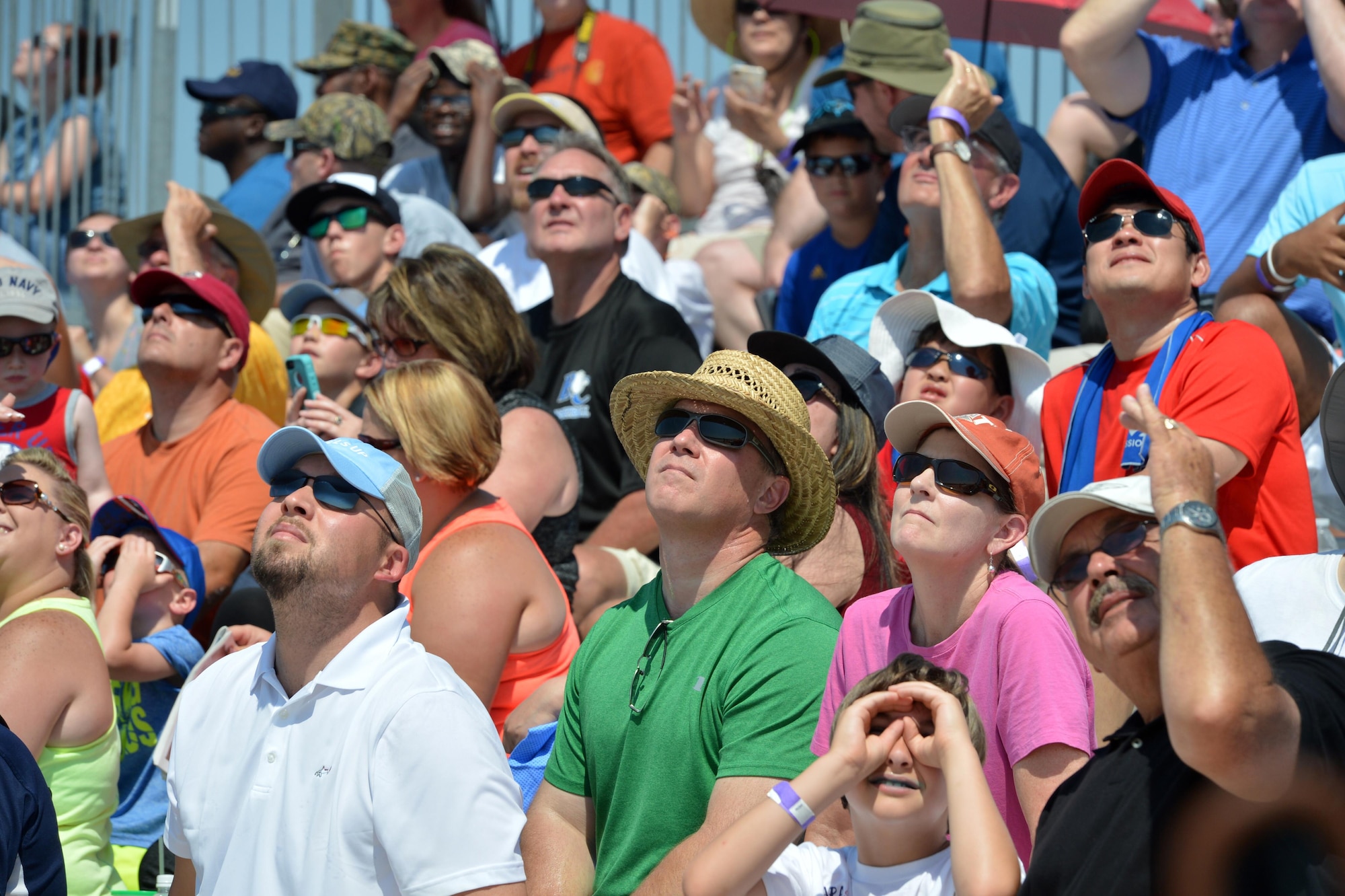 Attendees of the Wings Over Wayne Air Show watch aerial performances overhead, May 20, 2017, at Seymour Johnson Air Force Base, North Carolina. Seymour Johnson AFB opened its gates to the public for a free, two-day event as a way to thank the local community for their ongoing support of the base’s mission. (U.S. Air Force photo by Airman 1st Class Christopher Maldonado)