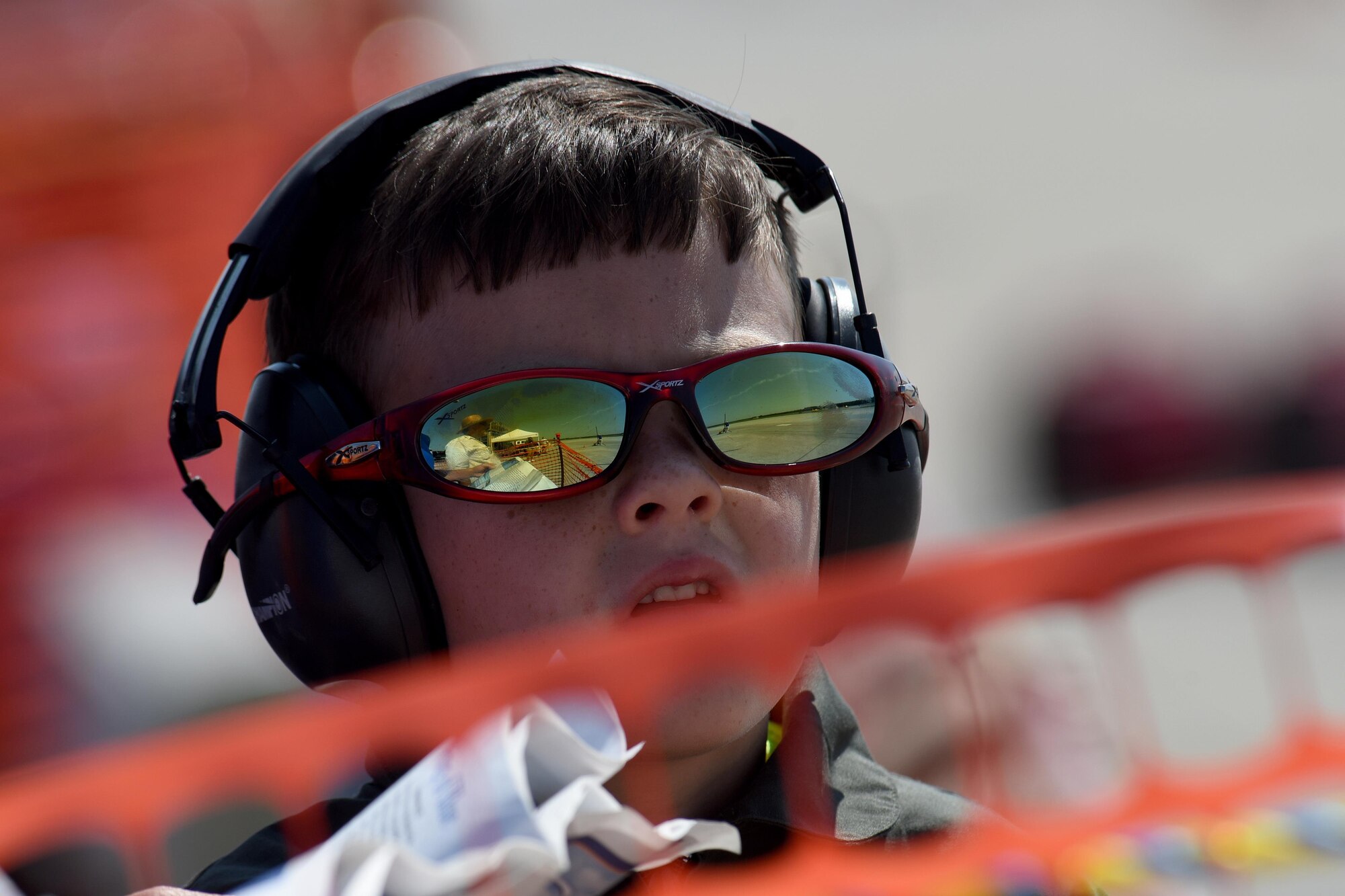 A young attendee of the Wings Over Wayne Air Show watches aerial performances overhead, May 20, 2017, at Seymour Johnson Air Force Base, North Carolina. Seymour Johnson AFB opened its gates to the public for a free, two-day event as a way to thank the local community for their ongoing support of the base’s mission. (U.S. Air Force photo by Airman 1st Class Miranda A. Loera)