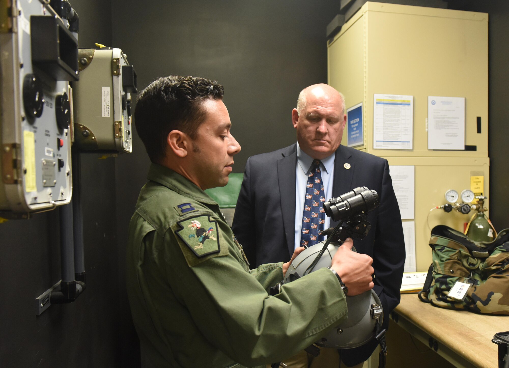 U.S. Rep. Glenn Thompson, R-Pa., toured the 193rd Special Operations Wing, Middletown, Pennsylvania, May 20. Capt. Eric Barnett, a pilot with the 193rd SOW, explains the benefits and drawbacks of the night vision goggles. He also reviewed how to assemble them and shared other flight equipment information. Thompson then got to test out the specialized goggles. (U.S. Air National Guard photo by Senior Airman Julia Sorber/Released)