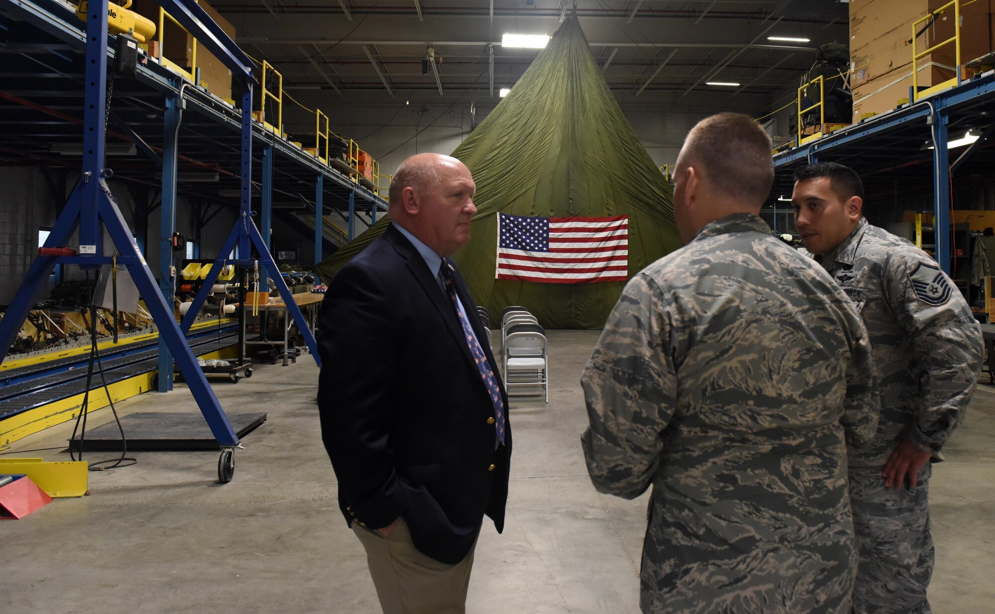U.S. Rep. Glenn Thompson, R-Pa., toured the 193rd Special Operations Wing, Middletown, Pennsylvania, May 20. Capt. Thomas Bagnell (center), installation deployment officer, and Master Sgt. Brian Sommers (right), air transportation specialist, both with the 193rd SOW, explain the various activities that go on inside the aerial port, to include preparing and securing cargo for airdrops. (U.S. Air National Guard photo by Senior Airman Julia Sorber/Released)