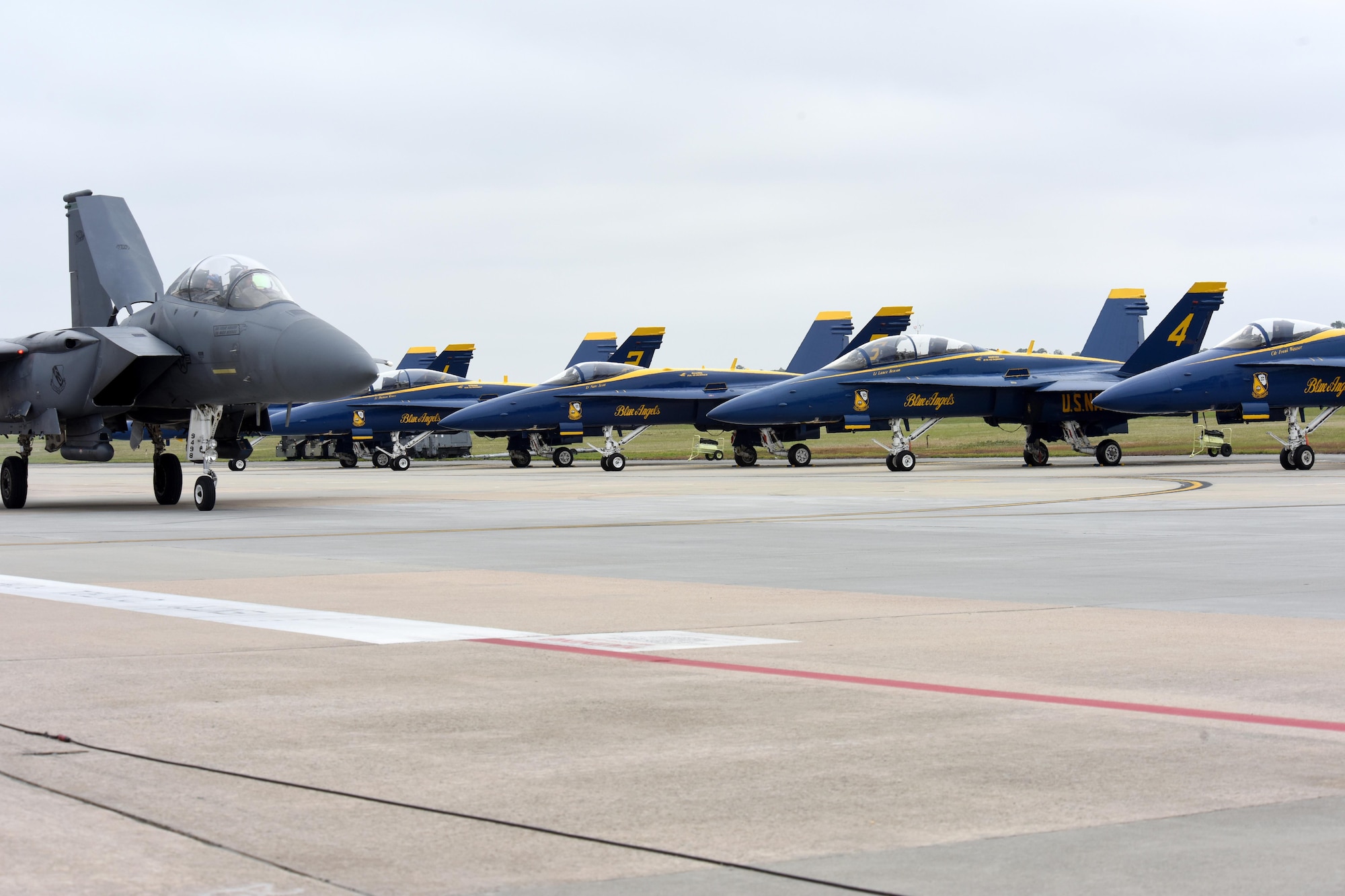 An F-15E Strike Eagle taxis in front of the U.S. Navy Blue Angels aircraft during the Wings Over Wayne Air Show, May 21, 2017, at Seymour Johnson Air Force Base, North Carolina. Later this year, the 4th Fighter Wing will celebrate its 75th anniversary with a weekend of heritage events and ceremonies. (U.S. Air Force photo by Airman 1st Class Miranda Loera)