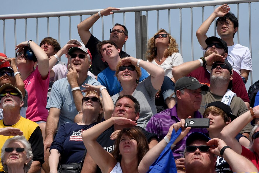 Attendees of the Wings Over Wayne Air Show watch aerial performances overhead, May 21, 2017, at Seymour Johnson Air Force Base, North Carolina. Seymour Johnson AFB opened its gates to the public for a free, two-day event as a way to thank the local community for their ongoing support of the base’s mission. (U.S. Air Force photo by Airman 1st Class Victoria Boyton)