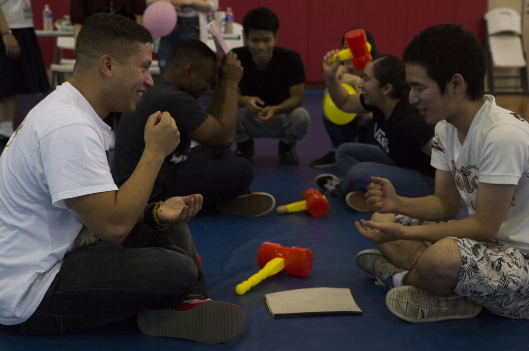 Marines with III Marine Expeditionary Force and Japanese students from Nikkei Business School in Okinawa City, Okinawa, Japan, play rock-paper-scissors at the House of Pain Fitness Center, on Camp Hansen, Okinawa, during the Okinawan-American Cultural Exchange Day, May 19, 2017. The Marines with III MEF Headquarters Group hosted the cultural exchange day to strengthen bonds between local nationals and service members, providing the two communities with the opportunity to converse and learn about each other’s culture. (U.S. Marine Corps photo by Lance Cpl. Charles Plouffe)