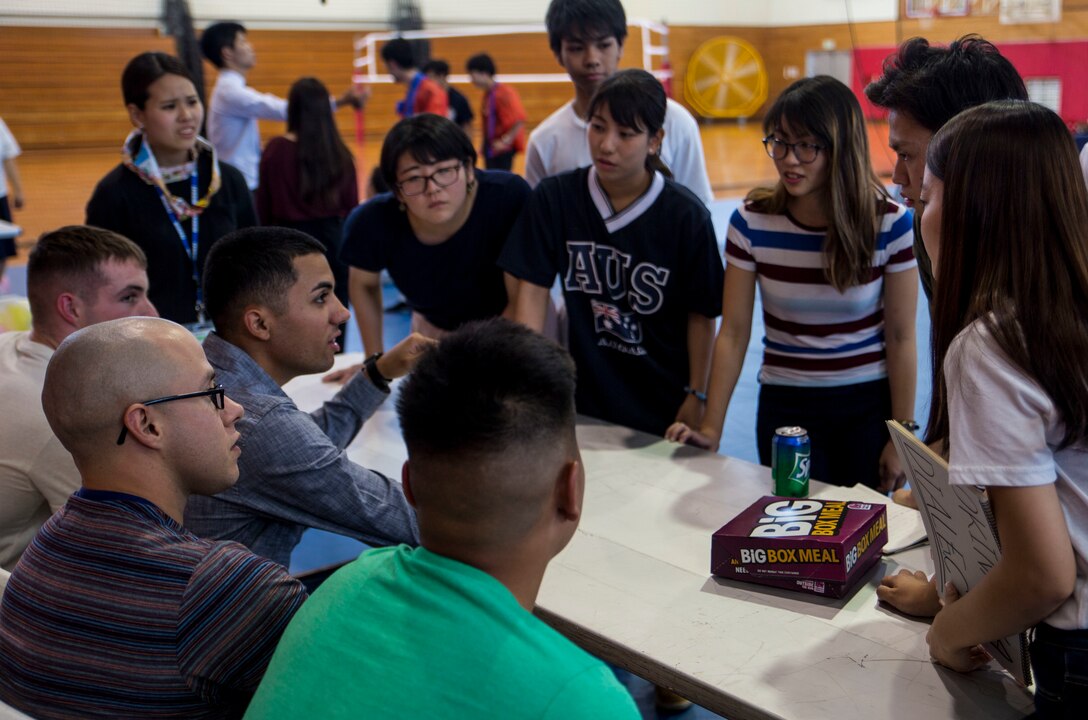 Marines with III Marine Expeditionary Force and Japanese students from Nikkei Business School in Okinawa City, Okinawa, Japan, teach each other Japanese and English phrases at the House of Pain Fitness Center, on Camp Hansen, Okinawa, during the Okinawan-American Cultural Exchange Day, May 19, 2017. The Marines with III MEF Headquarters Group hosted the cultural exchange day to strengthen bonds between local nationals and service members, providing the two communities with the opportunity to converse and learn about each other’s culture.(U.S. Marine Corp photo by Lance Cpl. Charles Plouffe)