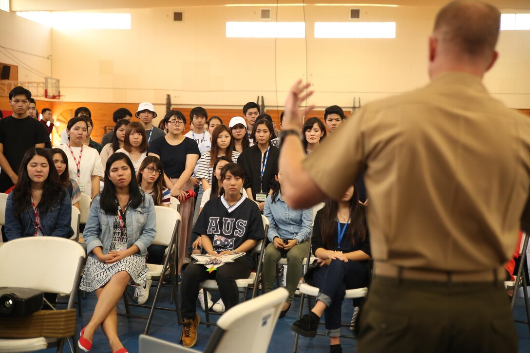 Lt. Col. Siebrand H. Niewenhous IV, commanding officer of Combat Logistics Battalion 31, 31st Marine Expeditionary Unit, addresses Japanese students from Nikkei Business School in Okinawa City during the Okinawan-American Cultural Exchange Day, May 19, 2017, at House of Pain Fitness Center, on Camp Hansen, Okinawa, Japan. The Marines gave presentations about American culture and military operations to Japanese college students from Okinawa City and Naha, Okinawa. Marines with III MEF Headquarters Group hosted the cultural exchange day to strengthen bonds between the local community and service members, providing the two communities with the opportunity to converse and learn about each other’s culture. Niewenhous, a native of Pacific Grove, California, is a graduate of California State University. (U.S. Marine Corps photo by Sgt. Tiffany Edwards)