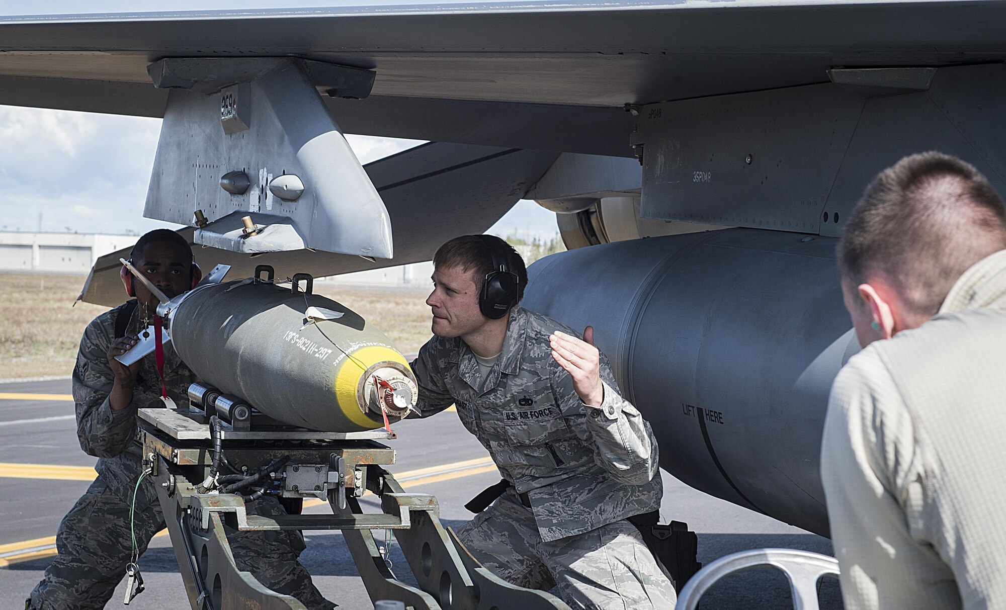 U.S. Air Force Airman 1st Class Hassan Cole, left, a 13th Aircraft Maintenance Unit weapons craftsman, Staff Sgt. Bryan Arbogast, center, a 13th Aircraft Maintenance Unit weapons team chief, and Airman 1st Class Alec Walker, a 13th Aircraft Maintenance Unit weapons craftsman, load a Mark-82 munition during Distant Frontier at Eielson Air Force Base, Alaska, May 15, 2017. DF enhances Misawa Airmen response to any crises in the Indo-Asia-Pacific region. (U.S. Air Force photo by Tech Sgt. Araceli Alarcon)

