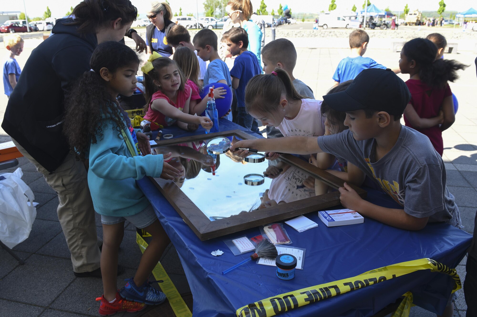 Spangdahlem Elementary School students learn about finger printing during U.S. National Police Week at Spangdahlem Air Base, Germany, May 16, 2017. NPW was established in 1962, by President John F. Kennedy, to honor the bravery and sacrifices of the men and women who serve as police officers. (U.S. Air Force photo by Senior Airman Dawn M. Weber)