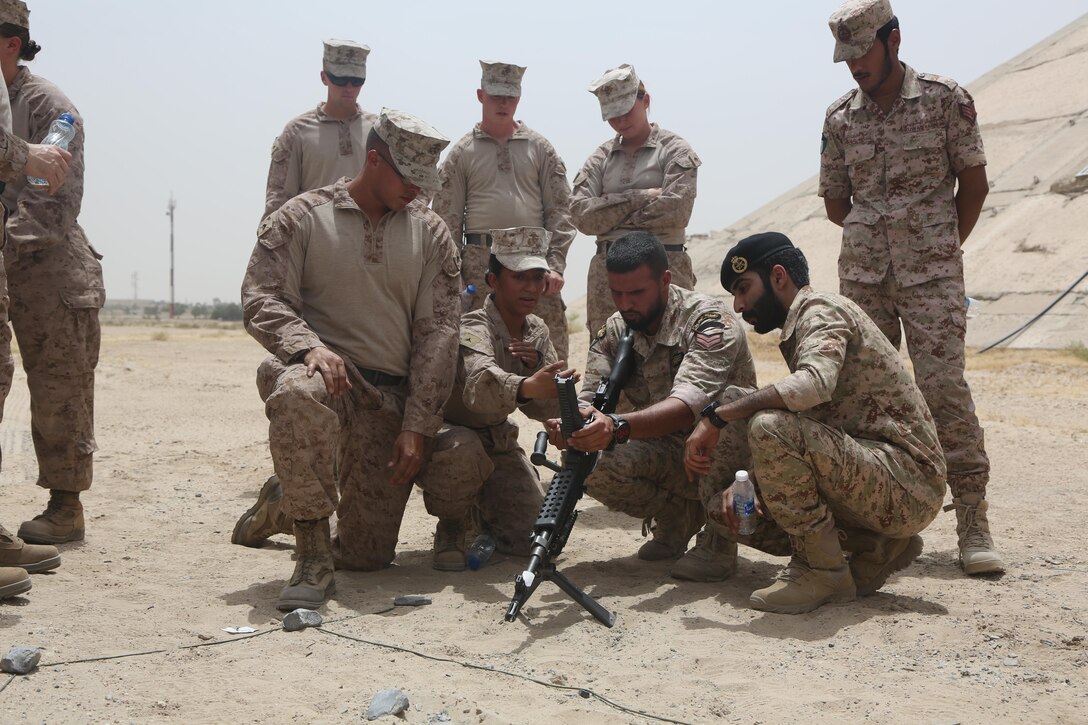 U.S. Marine Corps Cpl. Michael Pyle and Lance Cpl. Mikayla Lauer, motor vehicle operators with Special Purpose Marine Air-Ground Task Force-Crisis Response-Central Command, demonstrate to Kuwaiti Soldiers the proper use of the M240B machine gun in Kuwait, May 17, 2017.  The subject matter expert exchange between the U.S. Marines and Kuwaiti Army included M240B machine gun employment, uses of terrain models, and the capabilities of commonly used Marine vehicles. Deploying U.S. Marines into the USCENTCOM area of operations to conduct combined military training with our partner nations’ security forces strengthens our vital relationships with partners in this strategically important region.(U.S. Marine Corps photo by Lance Cpl Joshua S. McAlpine)