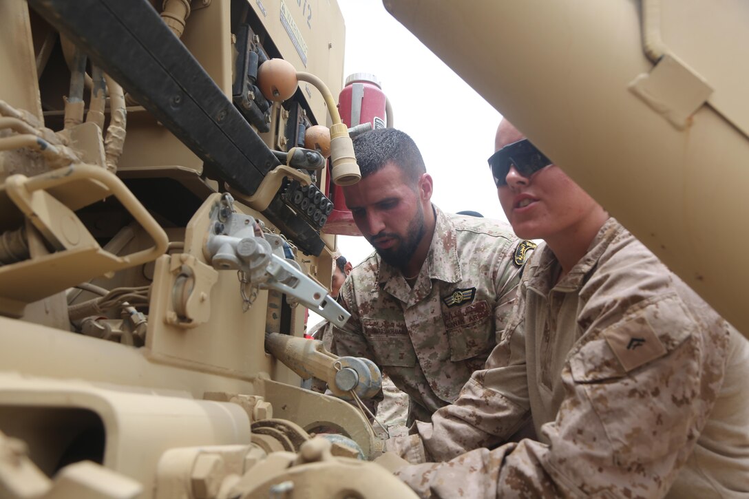 U.S. Marine Corps Lance Cpl. Elizabeth Culpepper, a motor vehicle operator with Special Purpose Marine Air-Ground Task Force-Crisis Response-Central Command, attaches a mine-resistant, ambush-protected vehicle (MRAP) to a logistic vehicle system replacement (LVSR) wrecker truck with a Kuwaiti Solder in Kuwait, May 17, 2017. The training provided the Kuwaiti Soldiers an opportunity to get hands on experience with some of the Marine Corps equipment commonly used throughout the area of operations. Deploying U.S. Marines into the USCENTCOM area of operations to conduct combined military training with our partner nations’ security forces strengthens our vital relationships with partners in this strategically important region. (U.S. Marine Corps photo by Lance Cpl Joshua S. McAlpine)