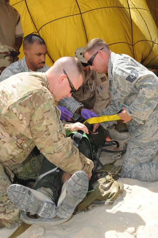 Members of the 380th Expeditionary Medical Group medical operations flight prepare a French pilot for transport during a joint crash exercise at an undisclosed location in Southwest Asia, May 16, 2017. Coalition forces responded to exercise locations at two different sites, testing how well partner first responders would work together in the event of an accident or incident. (U.S. Air Force photo by Staff Sgt. Marjorie A. Bowlden)