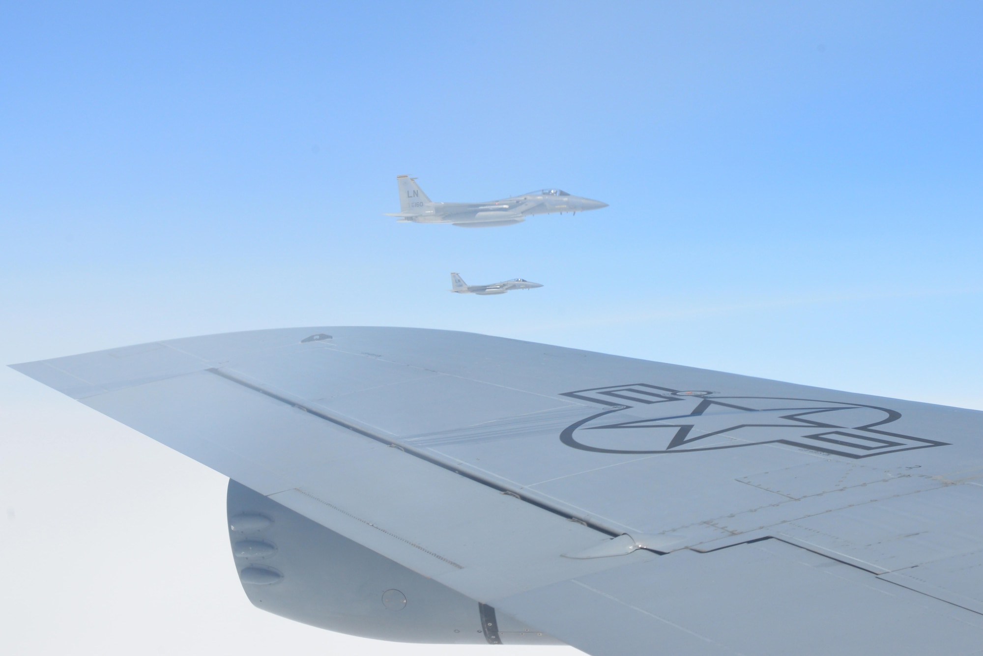 Two F-15 Eagle aircraft from RAF Lakenheath, England, fly in formation next to the KC-135 Stratotanker they just refueled from May 19, 2017. The KC-135 is assigned to RAF Mildenhall, England. All three aircraft are on their way to support Arctic Challenge 2017, a multinational exercise encompassing 11 nations and more than 100 aircraft. (U.S. Air Force photo by Tech. Sgt. David Dobrydney)