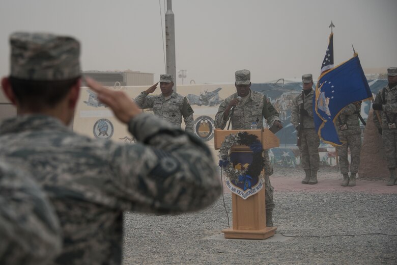 Senior Airman Jamon Simmons-Davenport, a 386th Expeditionary Security Forces Squadron member sings the national anthem through a sand storm during the Police Week closing ceremony at an undisclosed location in Southwest Asia, May 20, 2017.  The 386th and 387th Expeditionary Security Forces Squadrons held  a 2017 National Police Week closing ceremony in honor of those Law Enforcement Officers who have paid the ultimate sacrifice, in the line of duty, for the safety and protection of others. (U.S. Air Force photo/TSgt Jonathan Hehnly)