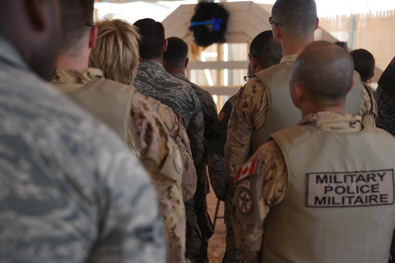 Canadian and American military police members stand together during the opening ceremony for 2017 Police Week at an undisclosed location in Southwest Asia, May 14, 2017. The 386th and 387th Expeditionary Security Forces Squadrons held a 2017 National Police Week Remembrance ceremony in honor of those Law Enforcement Officers who have paid the ultimate sacrifice, in the line of duty, for the safety and protection of others. (U.S. Air Force photo/TSgt Jonathan Hehnly)