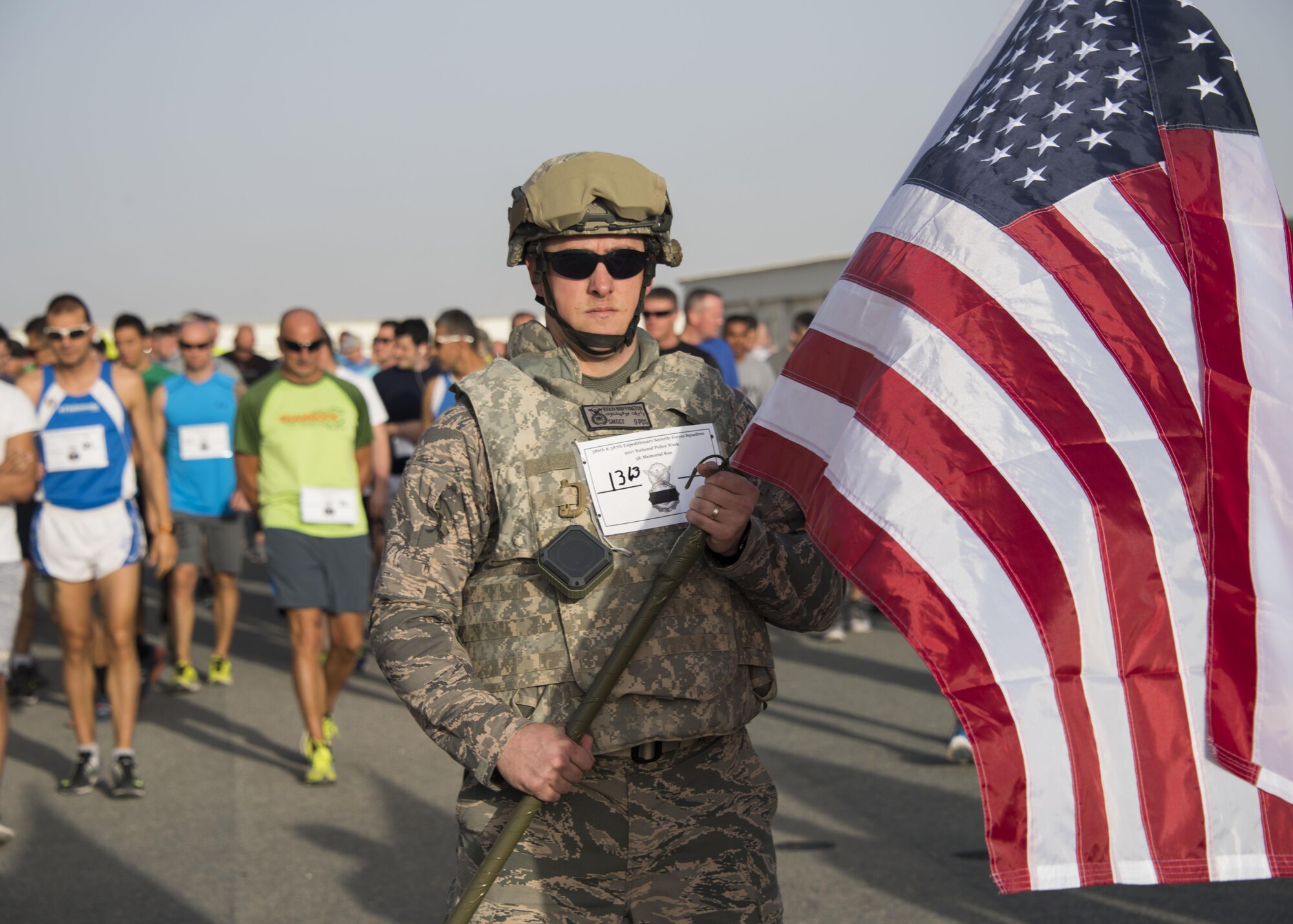 Senior Master Sgt. Ryan Buffington, the 386th Expeditionary Security Forces Squadron operations superintendent, prepares to lead the runners of the 2017 Police Week “5k for the fallen,” at an undisclosed location in Southwest Asia, May 16, 2017. Buffington ran the 5k wearing his flak vest and helmet in honor and memory of those SFS members who must endure black flag conditions in body armor. (U.S. Air Force photo/TSgt Jonathan Hehnly)