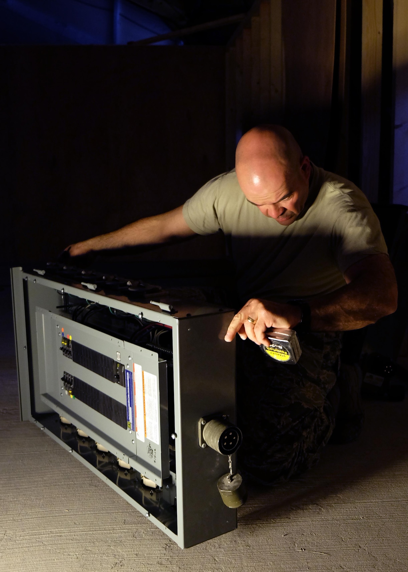 Tech. Sgt. Peter, 380th Expeditionary Civil Engineer Squadron electrician, measures a circuit-breaker box prior to mounting May 16, 2017, in southwest Asia. The 380th ECES is responsible for constructing and maintaining every US-controlled building on the installation. The project provided the 727th Expeditionary Air Control Squadron with offices inside a protective structure. (U.S. Air Force photo by Senior Airman Preston Webb)