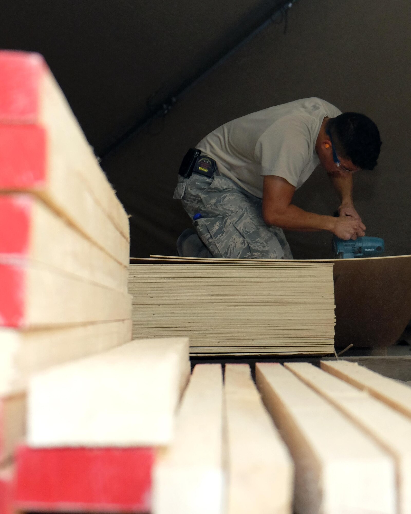Airman 1st Class El John Julius, 380th Expeditionary Civil Engineer Squadron carpenter, cuts lumber May 16, 2017, at an undisclosed location in southwest Asia. The project provided the 727th Expeditionary Air Control Squadron with new offices. (U.S. Air Force photo by Senior Airman Preston Webb)