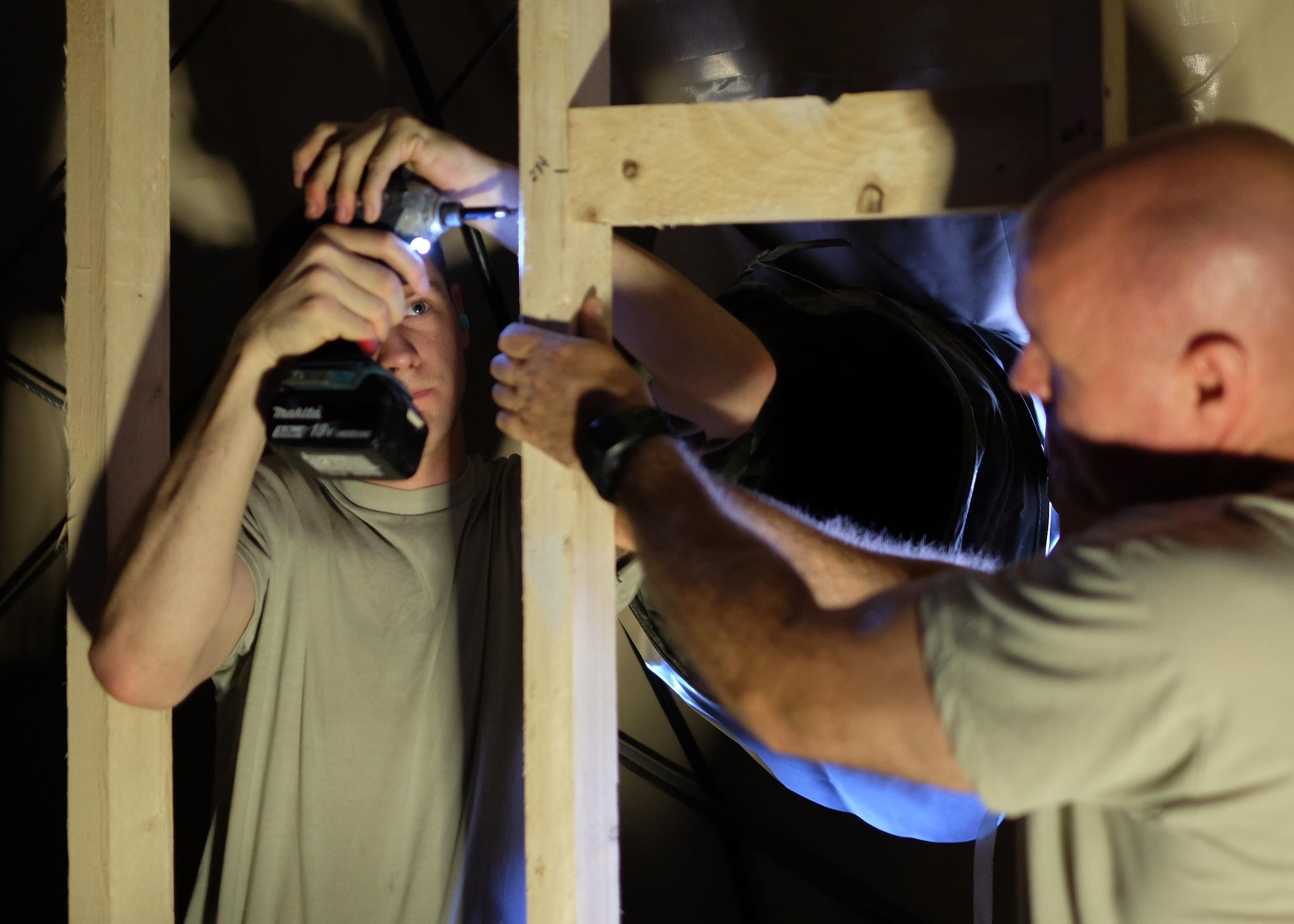 From left, Senior Airman Ryan and Staff Sgt. Ed, 380th Expeditionary Civil Engineer Squadron carpenters, frame a wall May 16, 2017, at an undisclosed location in southwest Asia. "Being a [380 ECES] Airman has changed my perspective about buildings on base," Ryan said. "I can hardly walk into a building without thinking about how I'd have approached the situation or how I could make it better." (U.S. Air Force photo by Senior Airman Preston Webb)