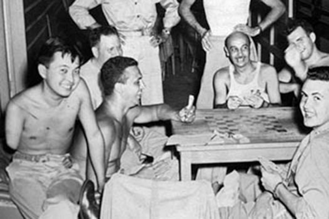 Army 2nd Lt. Daniel Inouye smiles with Bob Dole (front right) at Percy Jones Army Hospital in Battle Creek, Mich., after the war. Photo courtesy of Robert Dole Library