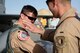 First Lt. Eric Tise, an F-16 Fighting Falcon pilot from the 555th Expeditionary Fighter Squadron, places a patch on Lt. Col. Vince O’Connor’s uniform at Bagram Airfield, Afghanistan, May 19, 2017. The patch was made to commemorate O’Connor surpassing the 2,000-hour mark for flying. O’Connor is the commander of the 555th EFS, which is deployed out of Aviano Air Base, Italy. (U.S. Air Force photo by Staff Sgt. Benjamin Gonsier)