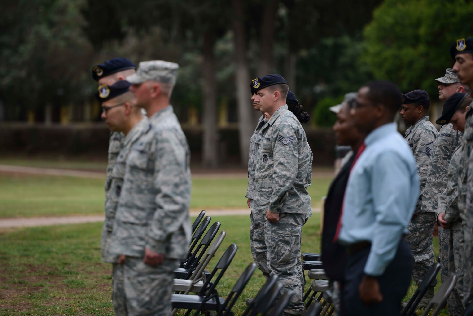 Airmen assigned to the 39th Air Base Wing bow their heads for a moment of silence, during the Incirlik Police Week 2017 closing ceremony May 18, 2017, at Incirlik Air Base, Turkey. National Police Week began in 1962 after President John F. Kennedy signed a proclamation designating May 15 as Peace Officers Memorial Day and the week in which that date falls as Police Week. (U.S. Air Force photo by Airman 1st Class Devin M. Rumbaugh)
