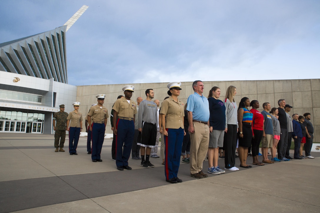 Marines and coaches stand at attention for a promotion ceremony during their visit to the National Museum of the Marine Corps as part of the 2017 Coaches Workshop, in Dumfries, Va., May 20. Thirty-five coaches travelled from across the U.S. to the Quantico area to learn about the Marine Corps' officer programs, how it vets candidates for Officer Candidates School, trains officers and develops its officer corps. The coaches received certificates for their attendance at the NMMC, which serves as a small token of appreciation for the coaches taking time out of their schedules to come aboard MCB Quantico to learn about the Corps.