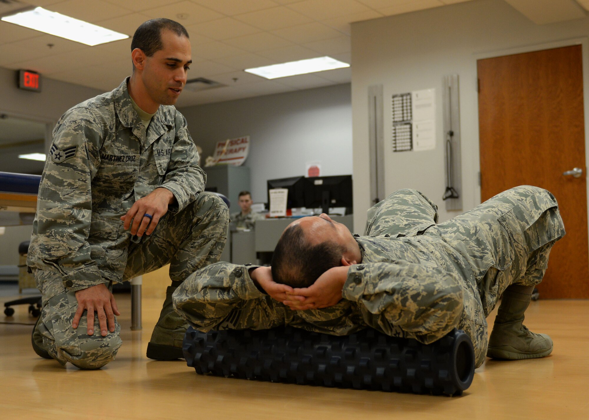 Senior Airman Hessen Martinez Cruz, 19th Medical Operations Squadron physical therapy technician, and Staff Sgt. Ralph Hallmon, 19th Medical Operations Squadron physical therapy technician, demonstrate an exercise, May 2, 2017 at the physical therapy clinic on Little Rock Air Force Base, Arkansas. From identifying problems to developing and implementing a care plan, physical therapy technicians like Martinez-Cruz work with patients as long as necessary so they can resume healthy, active lifestyles. (U.S. Air Force photo by Airman 1st Class Codie Collins)