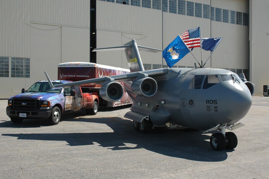 A miniature C-17 replica, the Spirit of Hope, Liberty and Freedom, sits in front of its trailer with new graphics provided by Air Force Reserve Command's Recruiting Service. Based at Charleston Air Force Base. S.C., the miniature C-17 travels around the country as a community-outreach and recruiting tool. (U.S. Air Force photo/Maj. Wayne Capps)