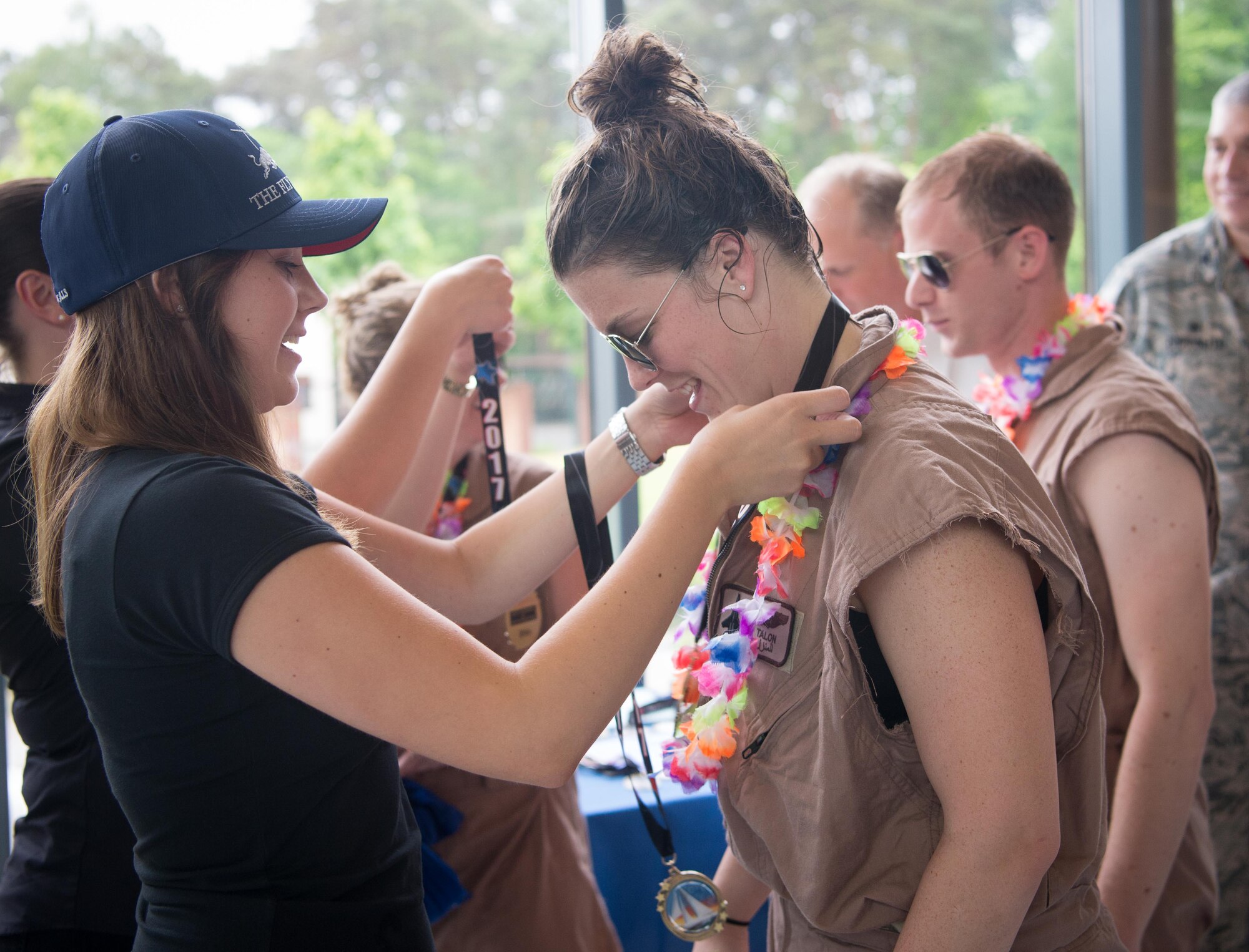 Members of the 37th Airlift Squadron's 2017 Battle of the Battleships team, Cloud Surfers, receive medals for "Most Outstanding Design" on Ramstein Air Base, May 19, 2017. Teams of Airmen assigned to various shops designed and built "battleships" out of cardboard and duct tape which they used to compete and gain aquatic superiority. The 86th Force Support Squadron Ramstein Aquatic Center hosts Battle of the Battleships annually to foster community and morale. (U.S. Air Force photo by Senior Airman Elizabeth Baker)