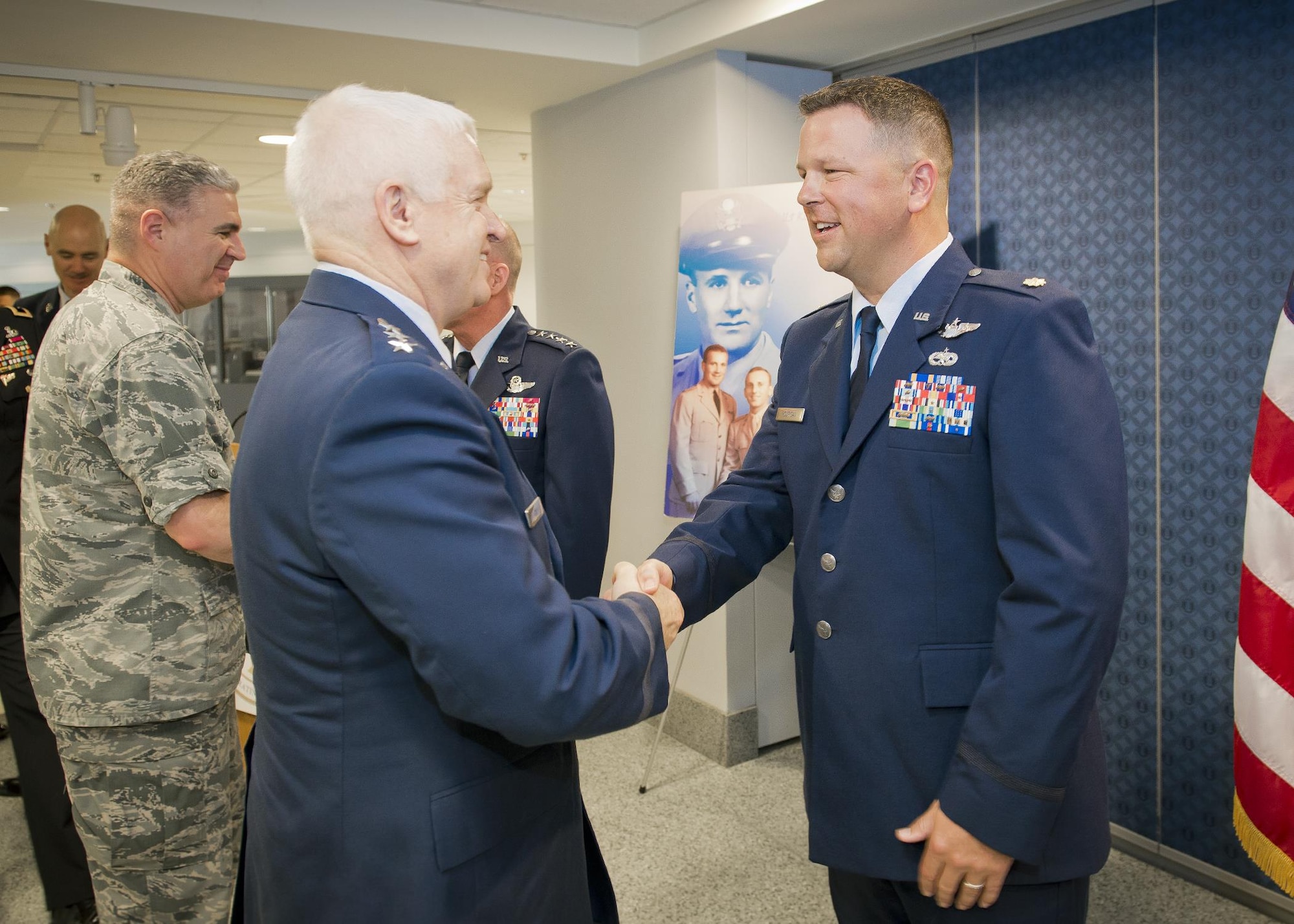 Lt. Gen. L. Scott Rice, director of the Air National Guard congratulates Maj. John Hourigan, a 123rd Operations Support Squadron C-130 Hercules pilot, after a ceremony where Hourigan received the Koren Kolligian Jr. Trophy at the Pentagon, Washington, D.C., May 17, 2017. On July 15, 2016, Hourigan’s aircraft began vibrating so badly that crew members were unable to communicate with each other through their headsets, read gauges or flight instruments. Hourigan quickly determined the source of vibration, implemented corrective action and executed an engine-out landing, saving the lives of all six crew members on board. (U.S. Air National Guard photo by Master. Sgt. Marvin R. Preston)