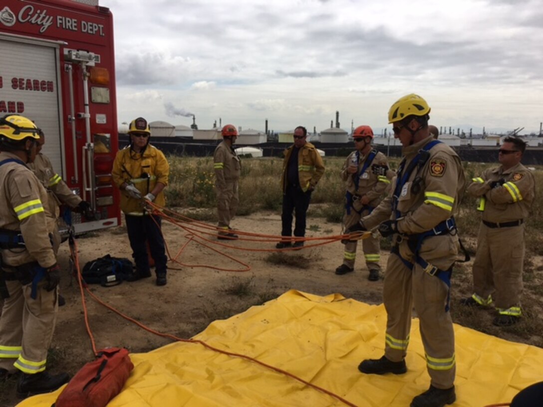 Los Angeles Fire Department rescue line and debrief at DFSP San Pedro Tank 15 during confined space and rescue training.