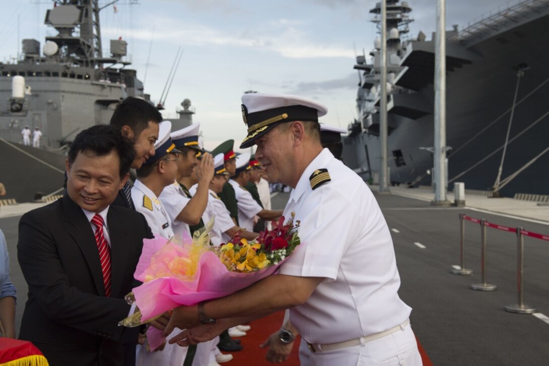 U.S. Navy Capt. Stanfield Chien, right, receives a welcoming gift from a Vietnamese government representative during the opening ceremony for Pacific Partnership 2017 in Cam Ranh, Khanh Hoa province, Vietnam, May 20, 2017. Navy photo by Petty Officer 2nd Class Chelsea Troy Milburn