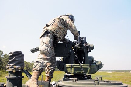 Staff Sgt. Devron West, a chemical, biological, radiological and nuclear specialist with the U.S. Army Reserve’s 300th Chemical Company from Morgantown, West Virginia, loads ammunition in the M2 .50 caliber machine gun May 19 during live-fire qualifications at Joint Base McGuire-Dix-Lakehurst, New Jersey.