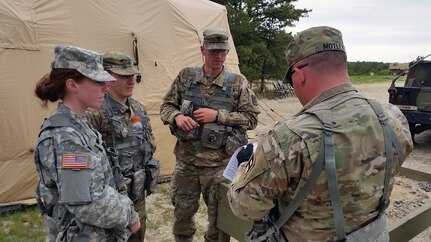 Soldiers from the U.S. Army Reserve’s 300th Chemical Company from Morgantown, West Virginia, receive their scores May 19 following .50 caliber live-fire qualifications at Joint Base McGuire-Dix-Lakehurst, New Jersey.  The exercise at JBMDL is an extension of the recently concluded Cold Steel, which took place at Fort McCoy, Wisconsin.