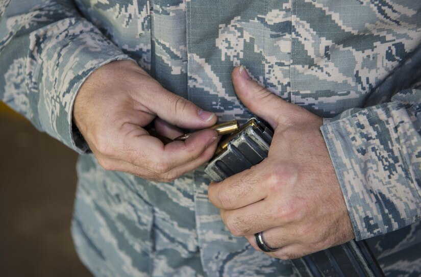 Tech. Sgt. Richard Atchinson, 437th Maintenance Group maintenance operations control center senior controller, loads a magazine before a firing competition at Joint Base Charleston, S.C., May 17, 2017. Several events, including an M4 carbine firing competition, were held in honor of Police Week.