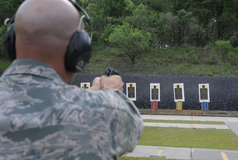 Master Sgt. Chris Moffett, 628th Civil Engineer Squadron heavy repair superintendent, aims his weapon during a shooting competition at Joint Base Charleston-Weapons Station, S.C., May 18, 2017. Several events, including an M9 pistol firing competition, were held in honor of Police Week.