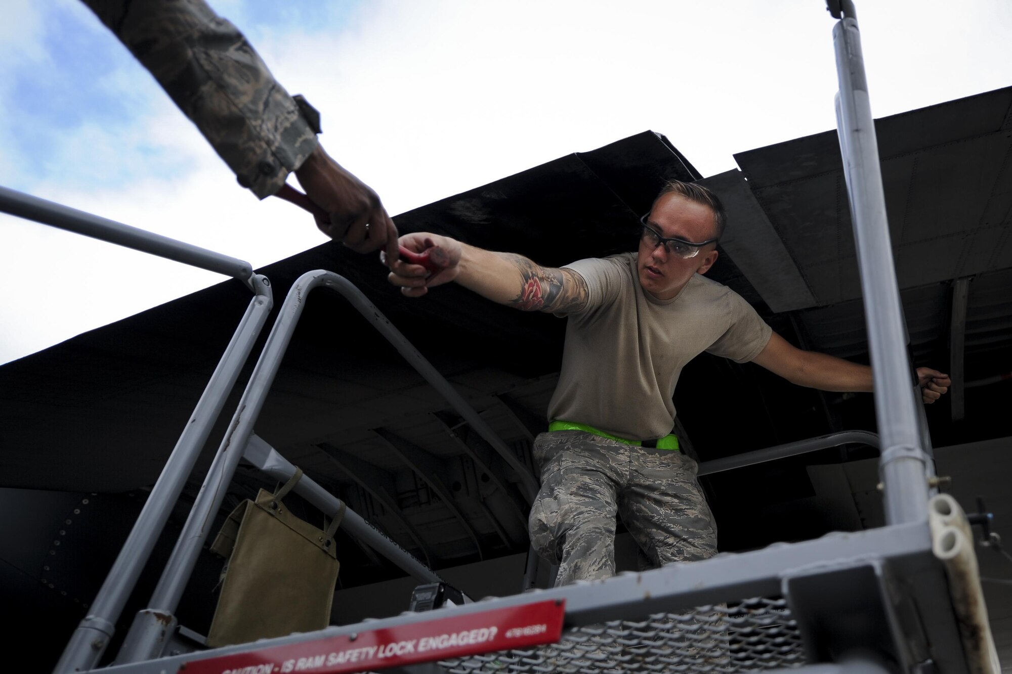 Airman 1st Class Jesse Coulter, a crew chief with the 4th Aircraft Maintenance Unit, grabs a mallet at Hurlburt Field, Fla., May 19, 2017. Coulter aided in the installation of a flat baffle on an AC-130U Spooky gunship. A flat baffle is used to improve aerodynamics and reduce turbulence during flight. (U.S. Air Force photo by Airman 1st Class Dennis Spain)