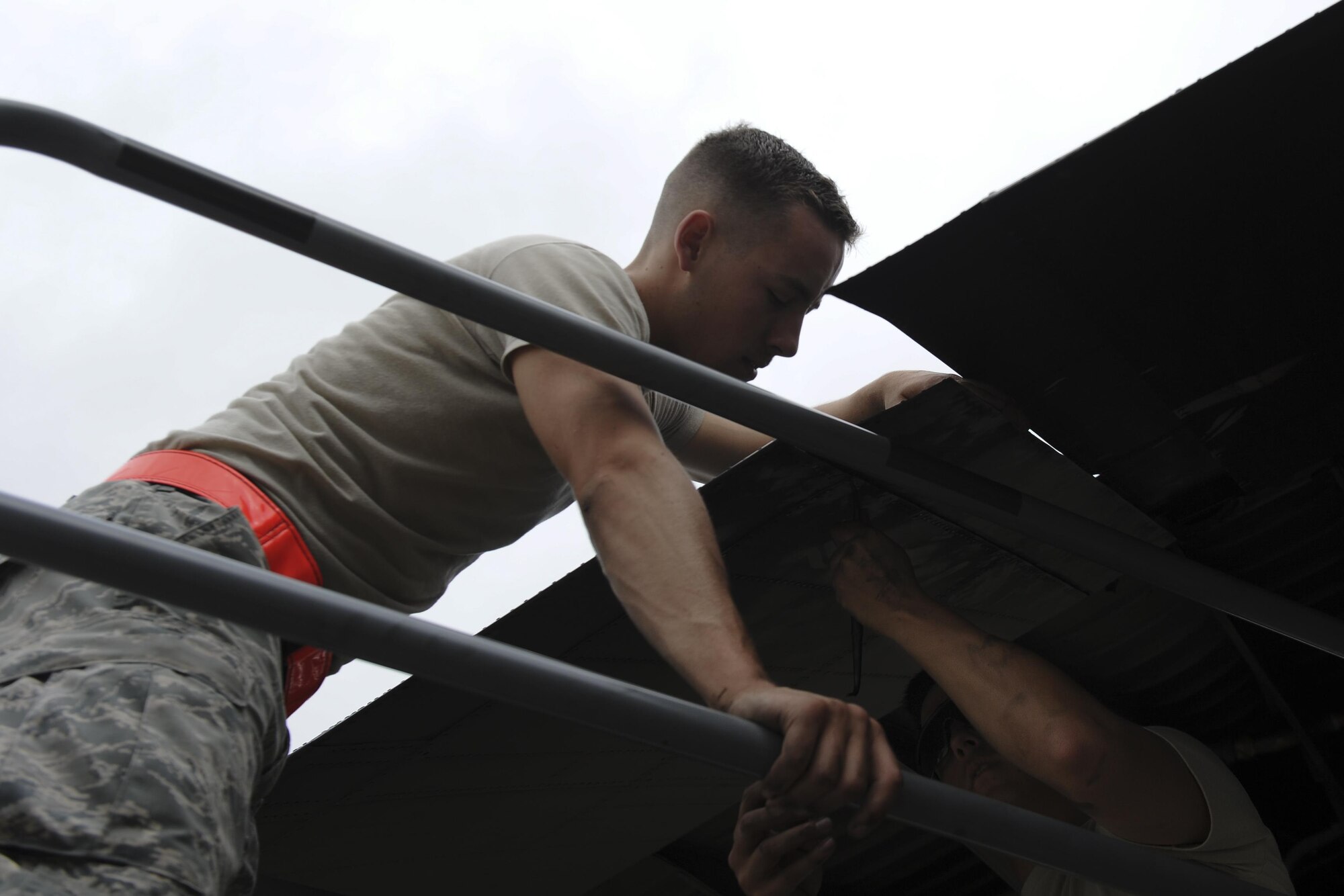 Airmen 1st Class Austin Luke, left, and Daniel Goerdt, crew chiefs with the 4th Aircraft Maintenance Unit, install a flat baffle onto the wing of an AC-130U Spooky gunship at Hurlburt Field, Fla., May 19, 2017. A flat baffle keeps turbulence to a minimum and aerodynamics to a maximum as the aircraft and its crew conduct special operations worldwide. (U.S. Air Force photo by Airman 1st Class Dennis Spain)