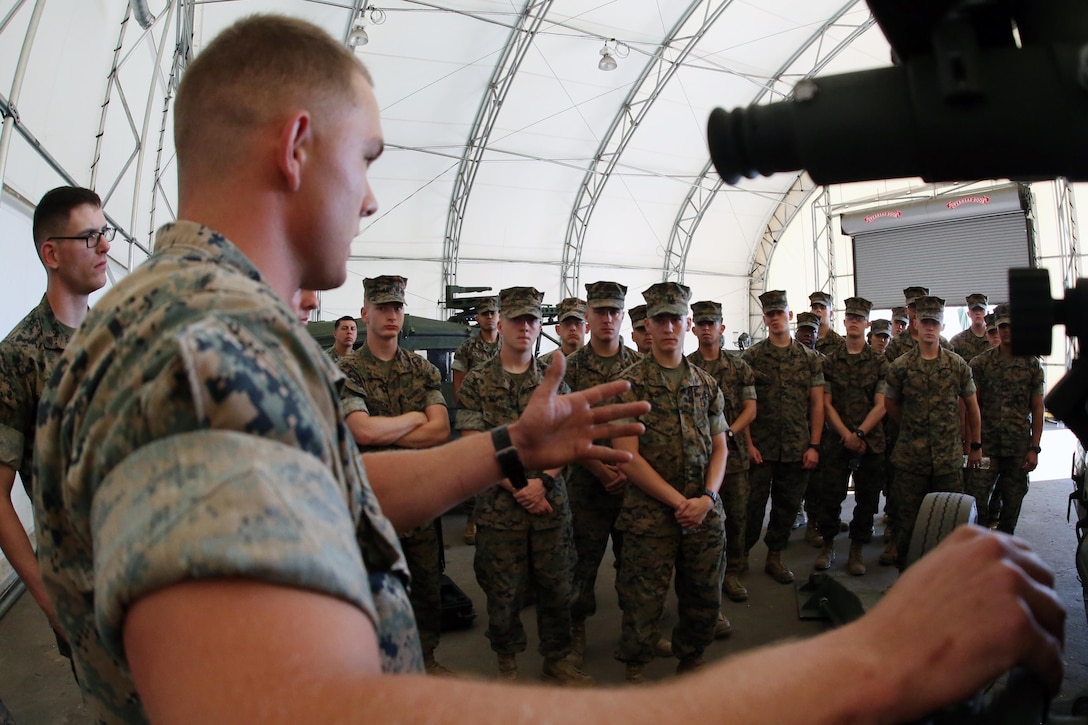 Sgt. Tyler Jackson gives a class about the M777 155mm Howitzer during a field trip at Marine Corps Base Camp Lejeune, N.C., May 16, 2017. Marines assigned to the Marine Corps Air Station Cherry Point Squadron Intelligence Training Certification Course had the opportunity to visit various units stationed at MCB Camp Lejeune, N.C. and MCAS New River, N.C., in order to provide them a better understanding about capabilities and limitations of aircraft, weapons systems and vehicles their units may utilize. Jackson is a field artillery cannoneer assigned to 2nd Battalion, 10th Marine Regiment, 2nd Marine Division. (U.S. Marine Corps photo by Cpl. Mackenzie Gibson/Released)