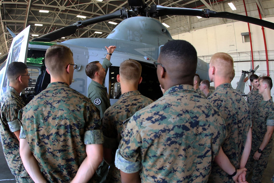 1st Lt. Robert Scoggin gives a class about the UH-1Y Venom during a field trip at Marine Corps Air Station New River, N.C., May 16, 2017. Marines assigned to the Marine Corps Air Station Cherry Point Squadron Intelligence Training Certification Course had the opportunity to visit various units stationed at MCB Camp Lejeune, N.C. and MCAS New River, N.C., in order to provide them a better understanding about capabilities and limitations of aircraft, weapons systems and vehicles their units may utilize. Scoggin is a pilot assigned to Marine Light Attack Helicopter Squadron 269, Marine Aircraft Group 14, 2nd Marine Aircraft Wing. (U.S. Marine Corps photo by Cpl. Mackenzie Gibson/Released)