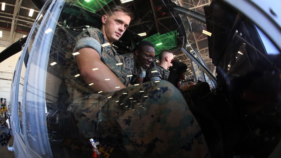 Lance Cpl. Mitch Gautreaux (left), Lance Cpl. Jeremiah Eaton explore the cockpit of a UH-1Y Venom during a field trip at Marine Corps Air Station New River, N.C., May 16, 2017. Marines assigned to the Marine Corps Air Station Cherry Point Squadron Intelligence Training Certification Course had the opportunity to visit various units stationed at MCB Camp Lejeune, N.C. and MCAS New River, N.C., in order to provide them a better understanding about capabilities and limitations of aircraft, weapons systems and vehicles their units may utilize. Gautreaux and Eaton are students assigned to the MCAS Cherry Point SITCC program. (U.S. Marine Corps photo by Cpl. Mackenzie Gibson/Released)