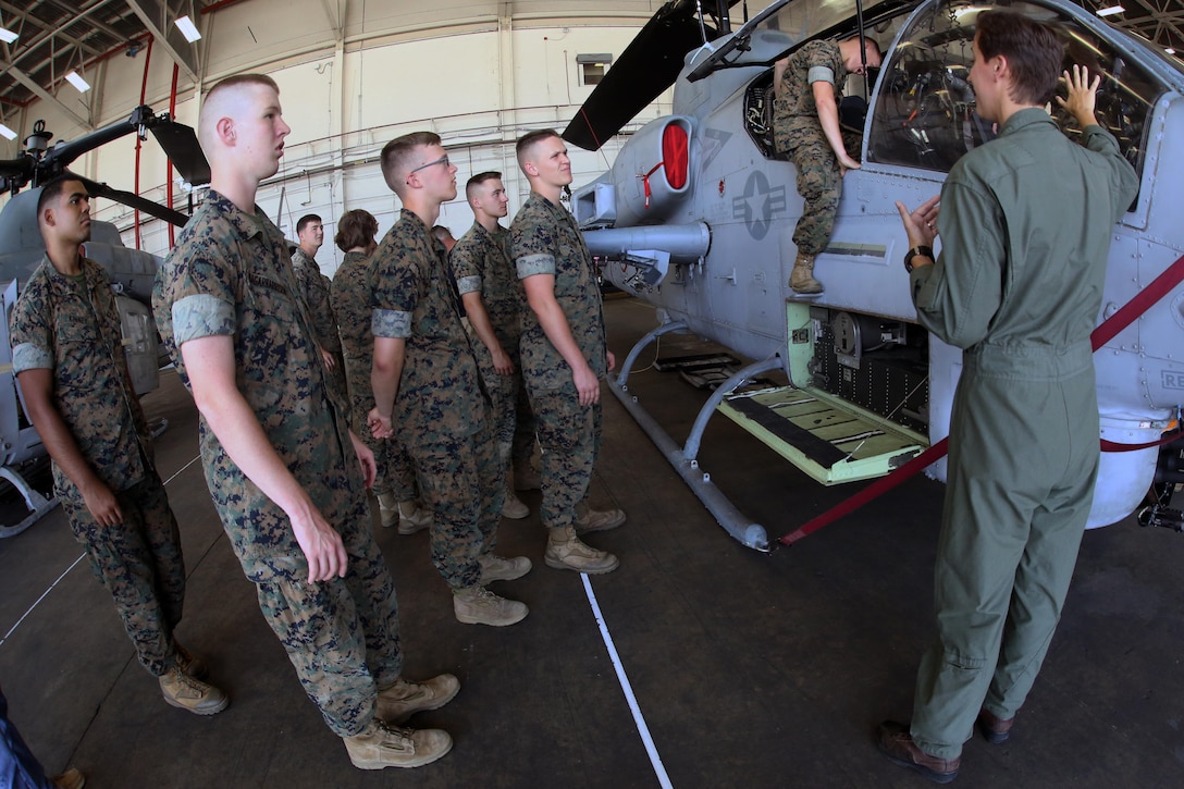 Capt. Victoria Ross gives a class about the AH-1W Super Cobra during a field trip at Marine Corps Air Station New River, N.C., May 16, 2017. Marines assigned to the Marine Corps Air Station Cherry Point Squadron Intelligence Training Certification Course had the opportunity to visit various units stationed at MCB Camp Lejeune, N.C. and MCAS New River, N.C., in order to provide them a better understanding about capabilities and limitations of aircraft, weapons systems and vehicles their units may utilize. Ross is a pilot assigned to Marine Light Attack Helicopter Squadron 269, Marine Aircraft Group 14, 2nd Marine Aircraft Wing. (U.S. Marine Corps photo by Cpl. Mackenzie Gibson/Released)