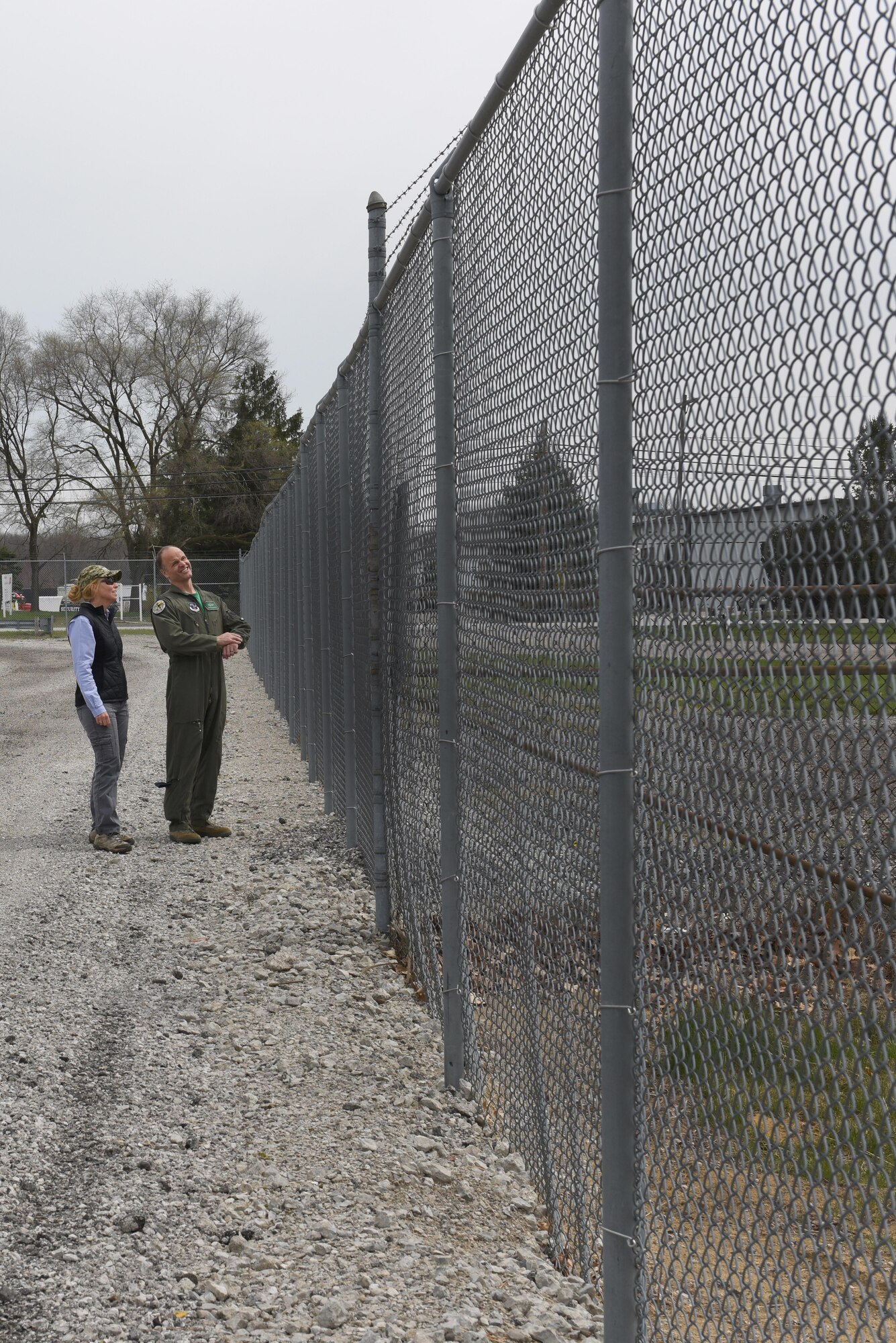 Director of Environmental Resource Solutions Southwest Florida Region and wildlife biologist, Sarah Brammell, assigned to the Air National Guard’s Bird Aircraft Strike Hazard team, and Lt. Col. Scott Schaupeter, 180th Fighter Wing’s director of ground and flying safety, evaluate the perimeter fencing around the 180FW airfield, April 13, 2017. Wildlife-related incidents were documented as the leading cause of F-16 fighter jet mishaps in the first quarter of 2017. In an effort to mitigate impact to the mission and maximize the safety of pilots, aircraft and the abundant local-area wildlife, the 180FW, Ohio Air National Guard, hosted a Bird Aircraft Strike Hazard team visit to assess potential bird and other wildlife hazards located on and around the airfield at Toledo Express Airport in Swanton, Ohio. Ohio. Air National Guard Photo by Senior Master Sgt. Beth Holliker.