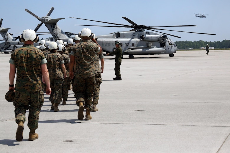 A group of Marines walk towards a CH-53E Super Stallion during a field trip at Marine Corps Air Station New River, N.C., May 16, 2017. Marines assigned to the Marine Corps Air Station Cherry Point Squadron Intelligence Training Certification Course had the opportunity to visit various units stationed at MCB Camp Lejeune, N.C. and MCAS New River, N.C., in order to provide them a better understanding about capabilities and limitations of aircraft, weapons systems and vehicles their units may utilize. (U.S. Marine Corps photo by Cpl. Mackenzie Gibson/Released)