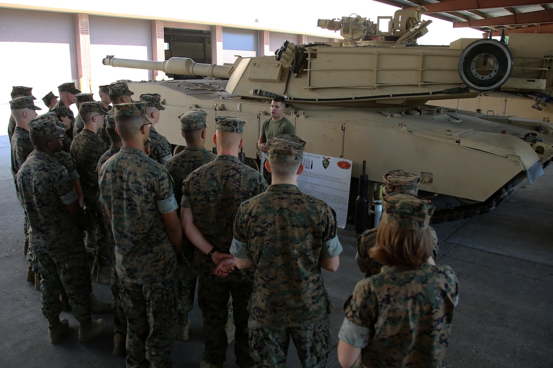 Staff Sgt. Cody Ferrell gives a class about the M1A1 Abrams tank during a field trip at Marine Corps Base Camp Lejeune N.C., May 16, 2017. Marines assigned to the Marine Corps Air Station Cherry Point Squadron Intelligence Training Certification Course had the opportunity to visit various units stationed at MCB Camp Lejeune, N.C. and MCAS New River, N.C., in order to provide them a better understanding about capabilities and limitations of aircraft, weapons systems and vehicles their units may utilize. Ferrell is an M1A1 tank crewman assigned to 2nd Tank Battalion, 2nd Marine Division. (U.S. Marine Corps photo by Cpl. Mackenzie Gibson/Released)