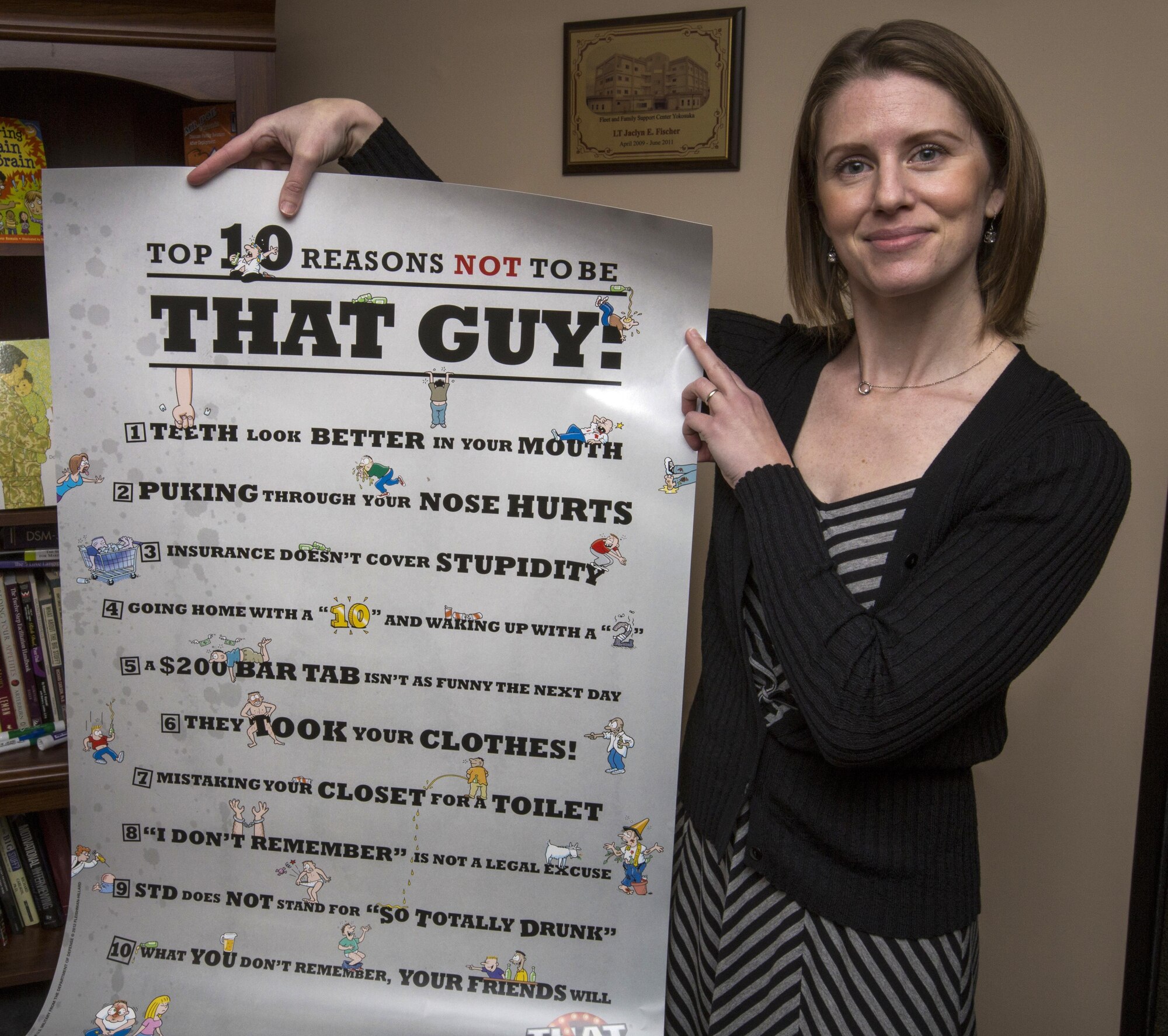 Jaclyn Urmey Director of Psychological Health, 514th Air Mobility Wing, Air Force Reserve; Reserve Command, holds a “That Guy” poster in her office at Joint Base McGuire-Dix-Lakehurst, N.J., May 20, 2017. “That Guy” is a Department of Defense campaign that was started in 2005 to reduce excessive binge drinking among 18- to 24-year-olds serving in the armed forces. (U.S. Air Force photo by Master Sgt. Mark C. Olsen/Released)