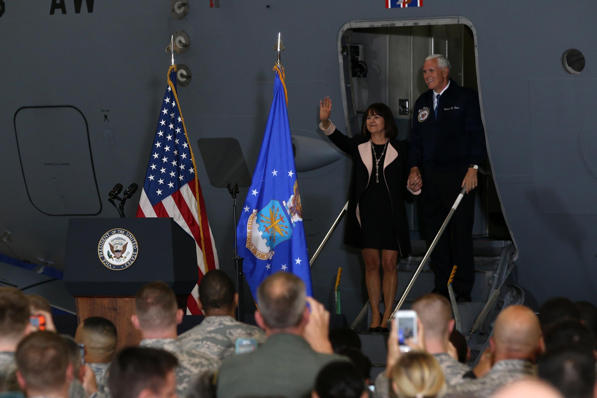 Vice President Mike Pence and his wife Karen wave to military members inside a 445th Airlift Wing hangar as they arrive to greet Airmen and their families, May 20, 2017 . The vice president visited Wright-Patterson Air Force Base to speak to approximately 250 Airmen and families to commemorate Armed Forces Day. (U.S. Air Force photo/Tech. Sgt. Patrick O’Reilly)