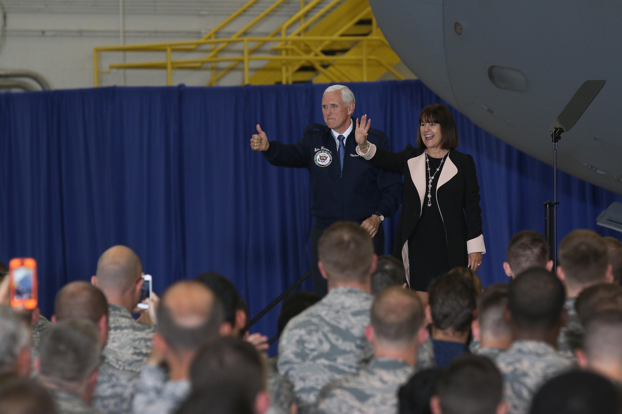 Vice President Mike Pence and his wife Karen wave to military members inside a 445th Airlift Wing hangar as they arrive to greet Airmen and their families, May 20, 2017 . The vice president visited Wright-Patterson Air Force Base to speak to approximately 250 Airmen and families to commemorate Armed Forces Day. (U.S. Air Force photo/Tech. Sgt. Patrick O'Reilly)