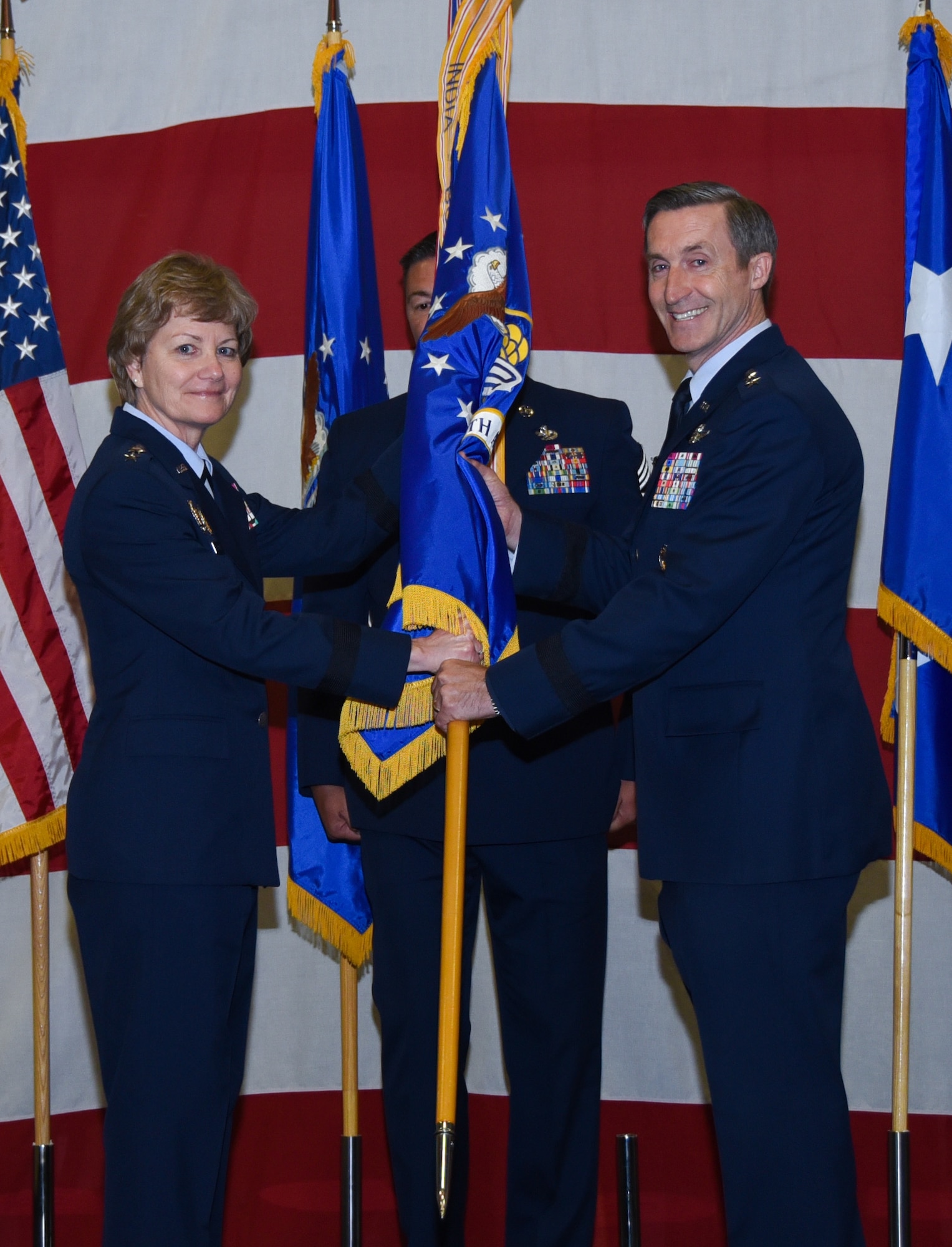 Lt. Gen. Maryanne Miller, chief of Air Force Reserve and commander, Air Force Reserve Command, gives the Tenth Air Force guidon to Maj. Gen. Ronald B. "Bruce" Miller, during a change of command ceremony, May 17, 2017 at Naval Air Station Fort Worth Joint Reserve Base, Texas. This will be Miller's second time to command a unit here, his first was the 301st Fighter Wing from 2010-2013. (U.S. Air Force photo by Ms. Julie Briden-Garcia)