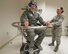 U.S. Air Force Tech. Sgt. Duane Thompson, USAF School of Aerospace Medicine operational physiology technician, gives the thumbs-up to Airman 1st Class Agnes Cattaneo, USAF School of Aerospace Medicine operational physiology technician, to start the Graveyard Spiral, as part of the Barany chair training for airsickness management program inside USAFSAM classroom at Wright-Patterson Air Force Base, Ohio, April 26, 2017.  The Barany chair is used as introductory spatial disorientation demonstrator and for rotational training as part of the airsickness management program. (U.S. Air Force photo/Michelle Gigante)