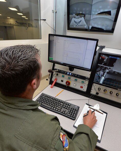 U.S. Air Force Tech. Sgt. Adam Tyler, USAF School of Aerospace Medicine operational physiology technician, enters preflight configurations for the school’s Centrifuge from the control room as part of a training program at Wright-Patterson Air Force Base, Ohio, April 26, 2017.  The centrifuge simulates a high-G environment used for training and evaluating aircrew on a properly performed anti-G straining maneuver, in a controlled environment. (U.S. Air Force photo/Michelle Gigante)